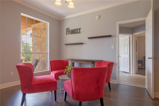 dining space featuring baseboards, crown molding, wood finished floors, and a chandelier