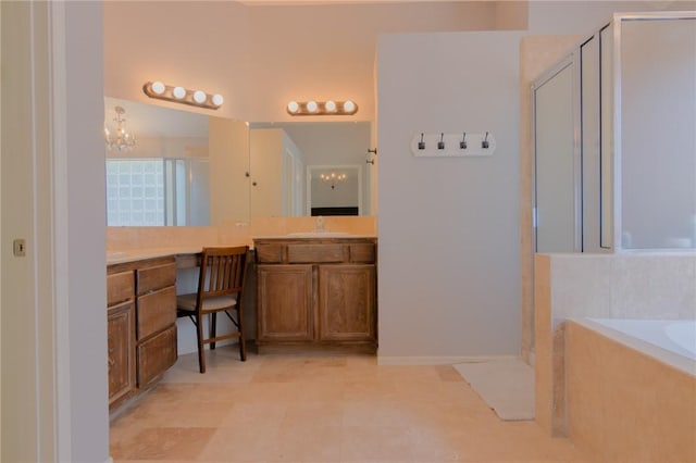 full bath featuring vanity, a shower stall, a bath, and a notable chandelier
