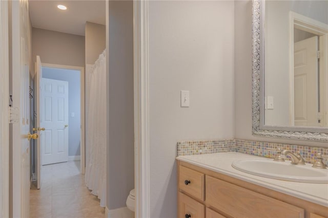 full bathroom featuring toilet, baseboards, tile patterned flooring, and vanity