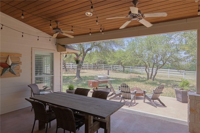 view of patio with outdoor dining area, a fenced backyard, and ceiling fan