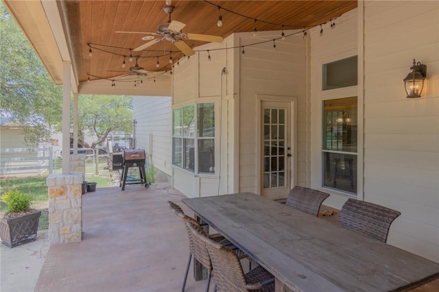 view of patio / terrace with fence, a ceiling fan, and outdoor dining space