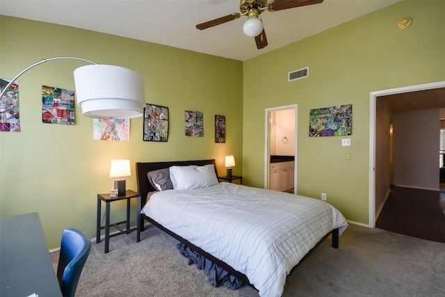 carpeted bedroom with a ceiling fan, baseboards, ensuite bathroom, a towering ceiling, and visible vents