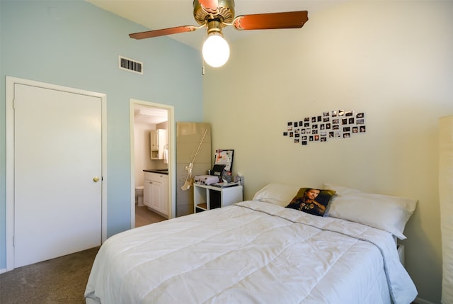 carpeted bedroom with connected bathroom, high vaulted ceiling, visible vents, and ceiling fan