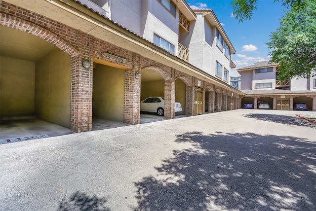 exterior space with brick siding and stucco siding