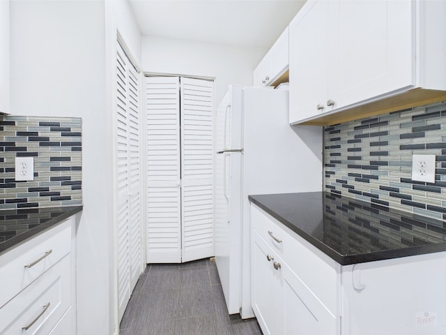 806 W 24th St Unit 312, Austin, TX 78705 - kitchen featuring tasteful backsplash, white cabinetry, and freestanding refrigerator