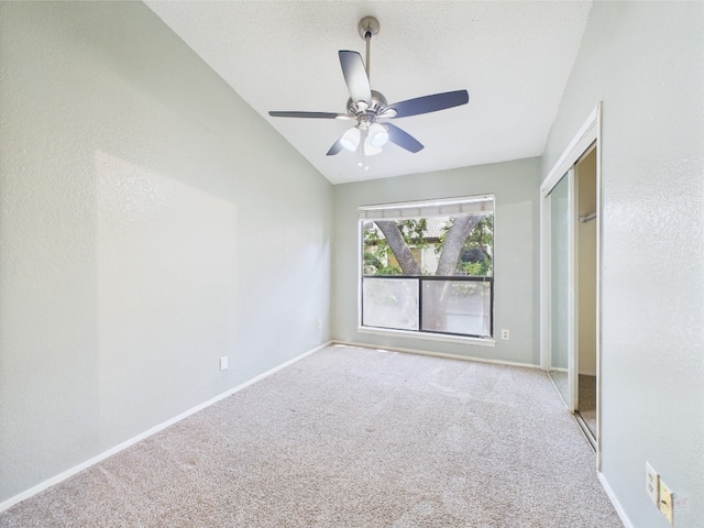 806 W 24th St Unit 312, Austin, TX 78705 - unfurnished bedroom with carpet flooring, vaulted ceiling, a closet, baseboards, and a ceiling fan