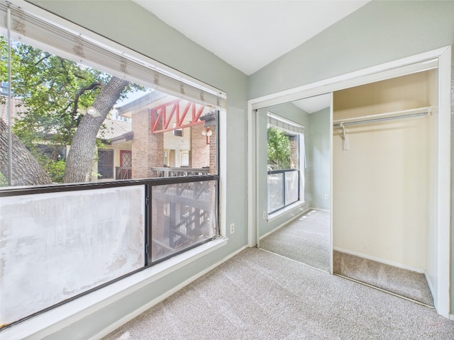 806 W 24th St Unit 312, Austin, TX 78705 - unfurnished bedroom with carpet flooring, lofted ceiling, a closet, and baseboards
