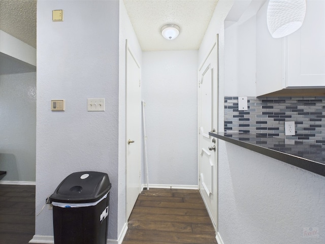806 W 24th St Unit 312, Austin, TX 78705 - hall featuring dark wood finished floors, baseboards, and a textured ceiling
