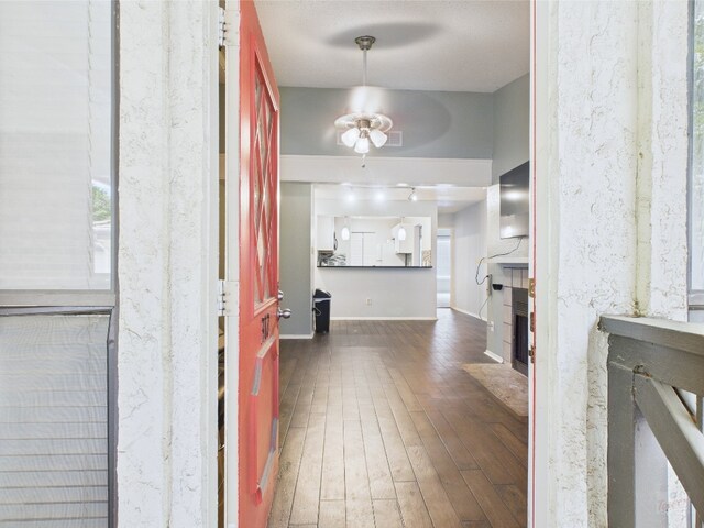 806 W 24th St Unit 312, Austin, TX 78705 - foyer with ceiling fan, hardwood / wood-style floors, a fireplace with flush hearth, and baseboards
