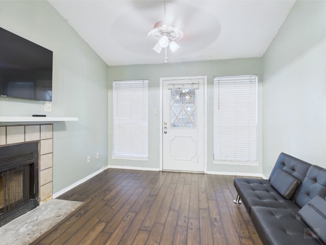 806 W 24th St Unit 312, Austin, TX 78705 - living room with a ceiling fan, baseboards, dark wood-type flooring, and a tile fireplace