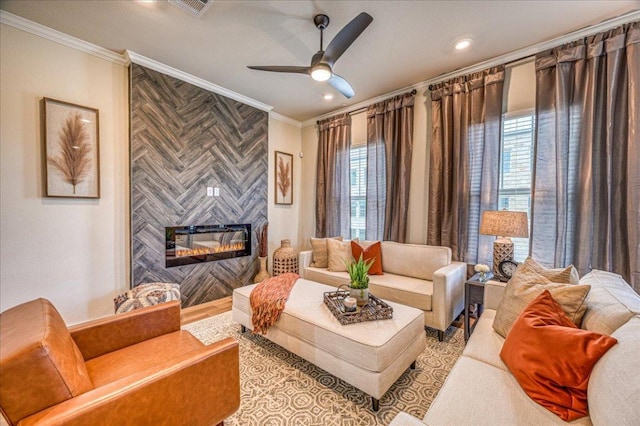 living area featuring ceiling fan, visible vents, crown molding, a fireplace, and recessed lighting