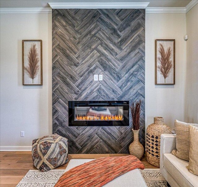 interior space featuring crown molding, baseboards, a fireplace, and wood finished floors