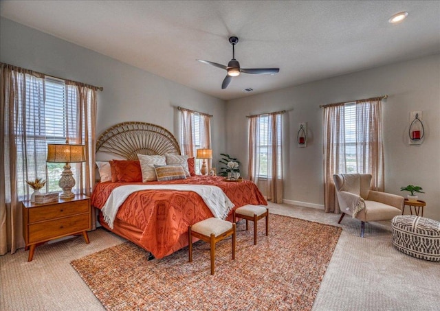 bedroom featuring light colored carpet and ceiling fan