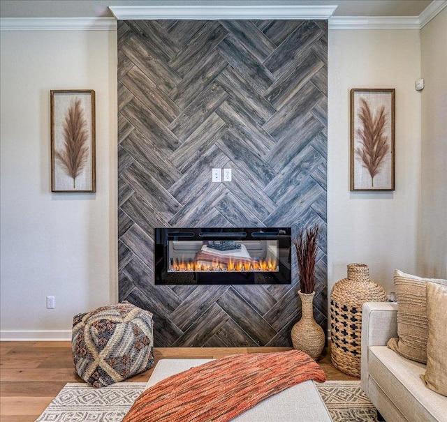 interior space featuring crown molding, baseboards, a fireplace, and wood finished floors