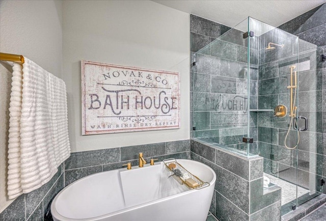 bathroom with a freestanding bath and a shower stall