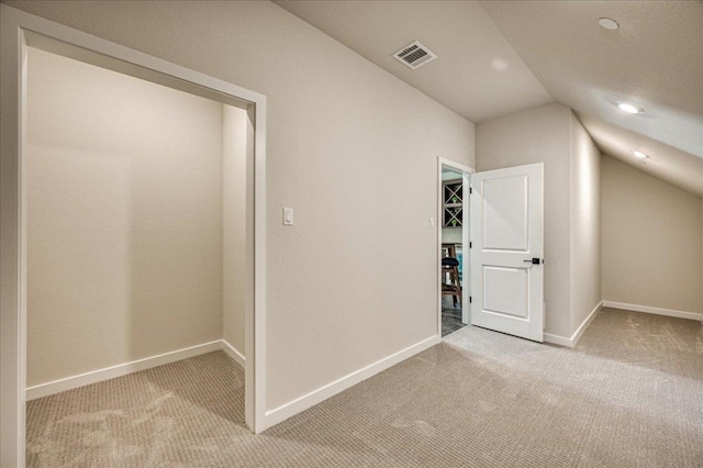 additional living space featuring visible vents, baseboards, recessed lighting, carpet flooring, and vaulted ceiling
