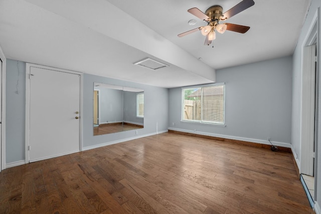 interior space featuring baseboards, ceiling fan, and wood finished floors