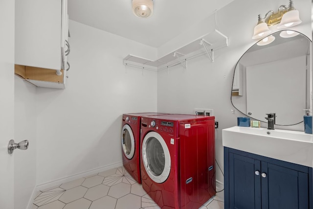 laundry room featuring a sink, baseboards, cabinet space, and washer and clothes dryer
