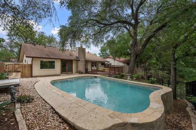 view of pool with a fenced backyard, a fenced in pool, and a deck