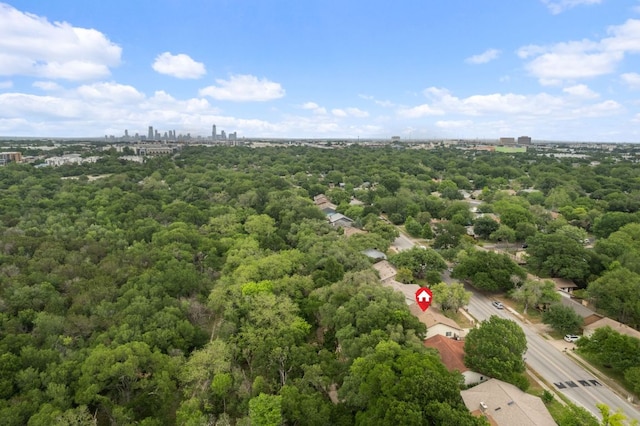 aerial view with a wooded view and a city view