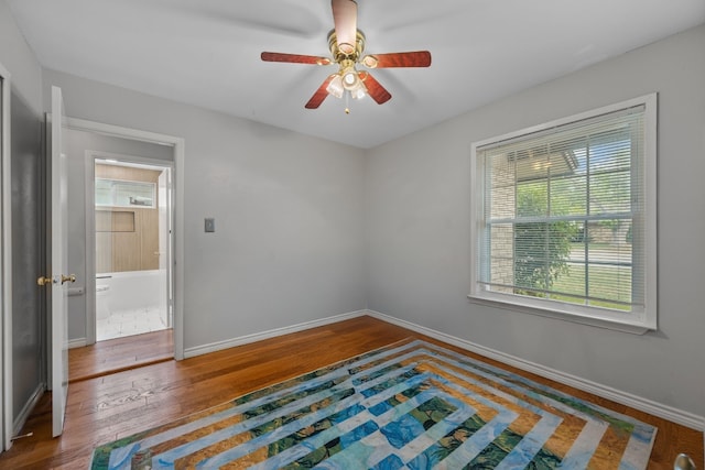 unfurnished bedroom with baseboards, ceiling fan, and hardwood / wood-style floors