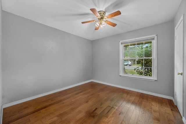 empty room with baseboards, ceiling fan, and hardwood / wood-style floors