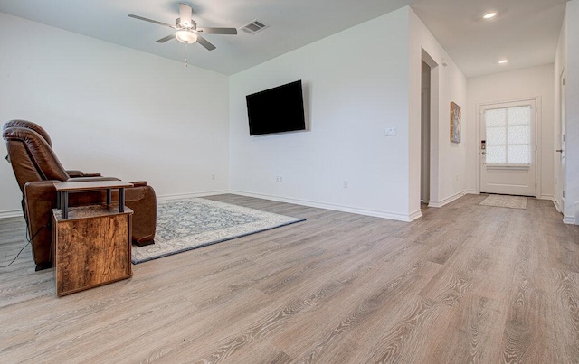 unfurnished room with visible vents, a ceiling fan, light wood-style floors, and baseboards