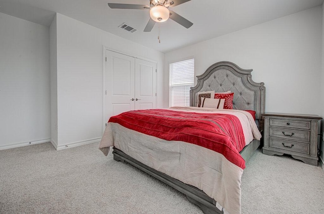 bedroom featuring carpet floors, visible vents, a closet, baseboards, and a ceiling fan