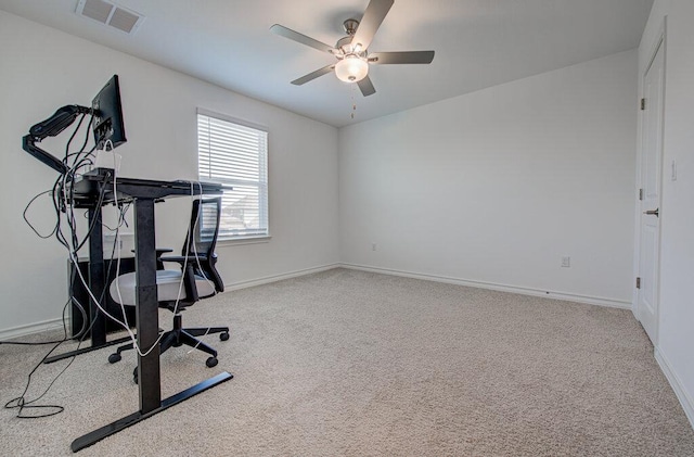 unfurnished office featuring visible vents, a ceiling fan, baseboards, and carpet flooring
