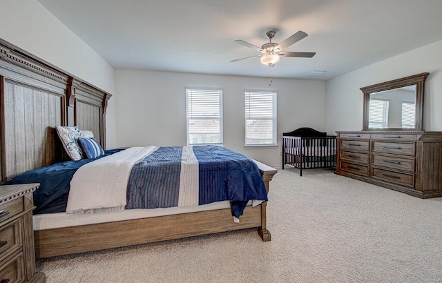 bedroom with ceiling fan and light carpet