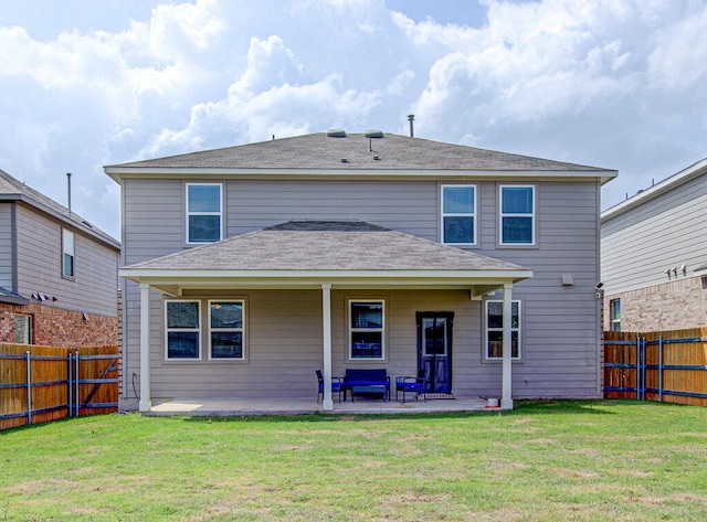 back of house with a fenced backyard, a patio, and a yard