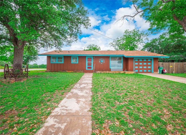 1207 Flag St, Llano, TX 78643 - ranch-style home featuring fence, a garage, board and batten siding, a front yard, and concrete driveway