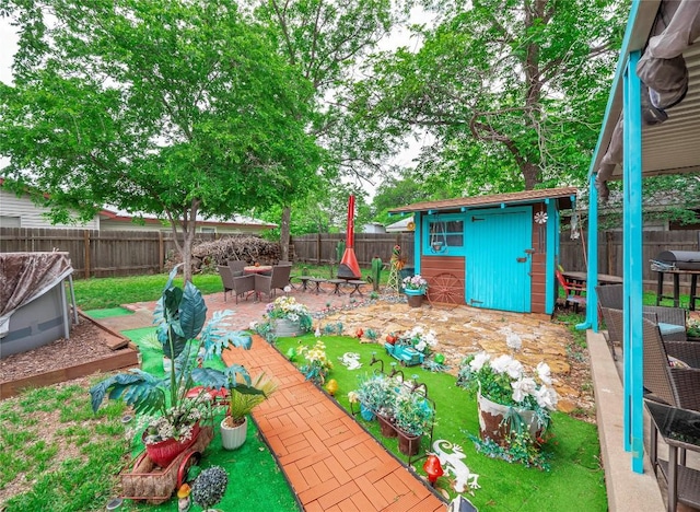 1207 Flag St, Llano, TX 78643 - view of yard with a storage shed, a patio, an outbuilding, and a fenced backyard