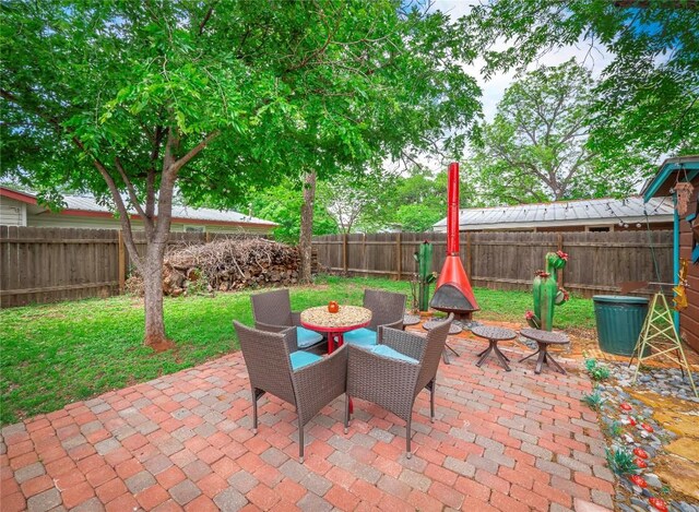 1207 Flag St, Llano, TX 78643 - view of patio / terrace featuring a fenced backyard and outdoor dining space