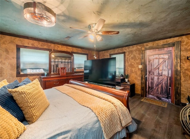 1207 Flag St, Llano, TX 78643 - bedroom featuring ceiling fan, baseboards, wallpapered walls, wood finished floors, and visible vents