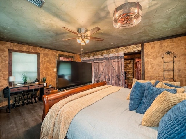 1207 Flag St, Llano, TX 78643 - bedroom featuring ceiling fan, wood finished floors, and visible vents