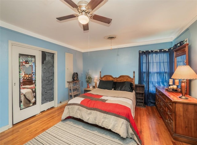1207 Flag St, Llano, TX 78643 - bedroom featuring ceiling fan, visible vents, and wood finished floors
