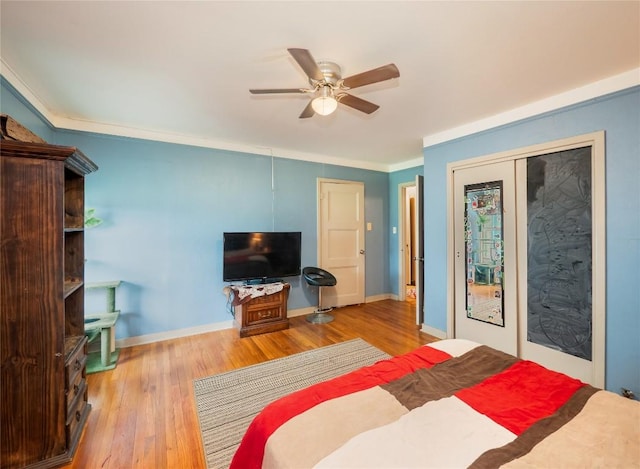 1207 Flag St, Llano, TX 78643 - bedroom with ornamental molding, ceiling fan, and wood finished floors