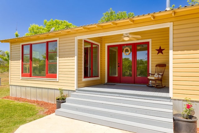 view of exterior entry featuring ceiling fan and french doors