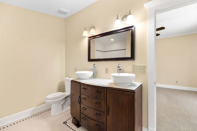 full bathroom featuring a sink, baseboards, toilet, and double vanity