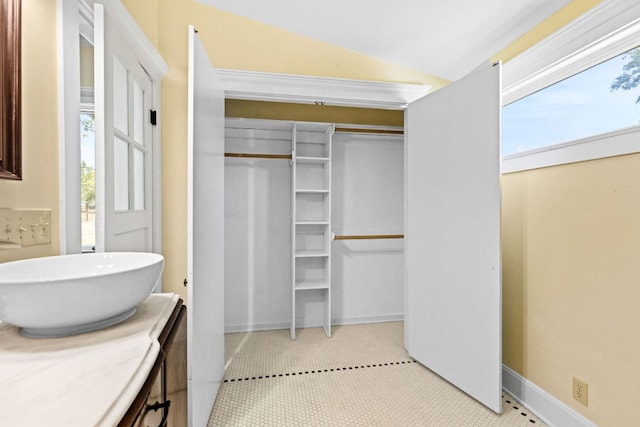 bathroom featuring lofted ceiling and vanity