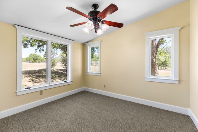 carpeted empty room with ceiling fan, vaulted ceiling, and baseboards