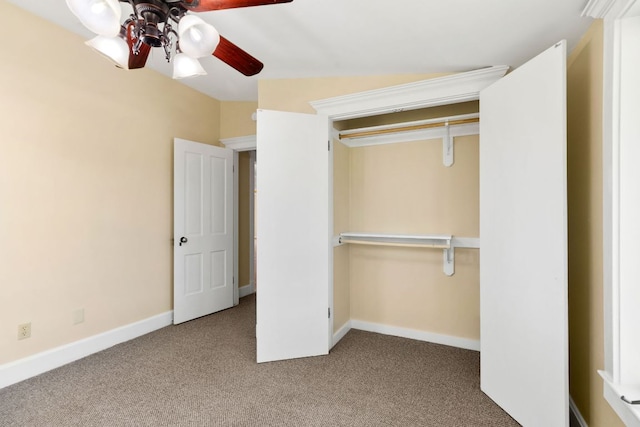 unfurnished bedroom with baseboards, carpet flooring, and a ceiling fan