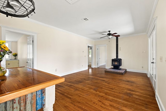 unfurnished living room with ceiling fan, ornamental molding, wood finished floors, and visible vents