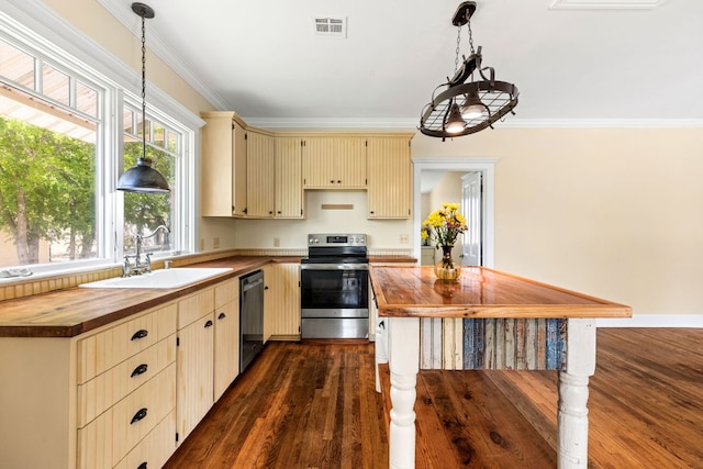 kitchen featuring visible vents, cream cabinets, a sink, butcher block counters, and stainless steel appliances