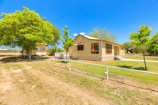 view of home's exterior featuring a yard, an outbuilding, and a storage unit