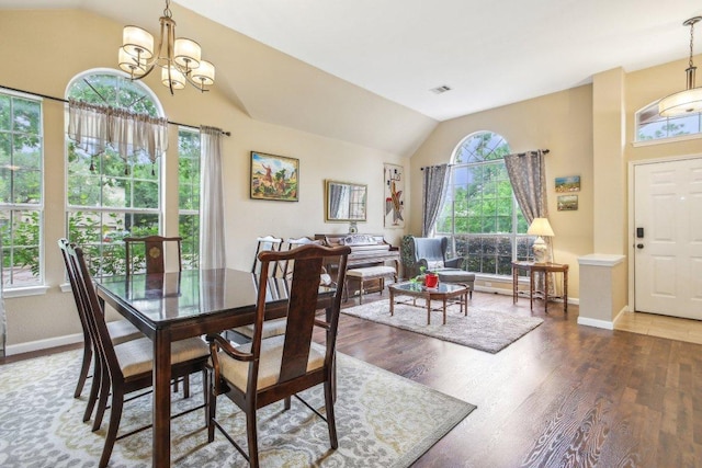 dining room featuring baseboards, vaulted ceiling, wood finished floors, and visible vents