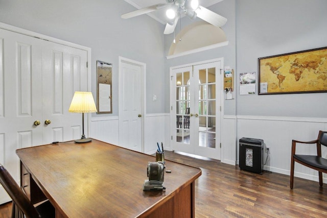 home office with french doors, a ceiling fan, wainscoting, and dark wood-style floors