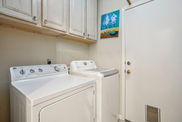 washroom with washer and dryer and cabinet space