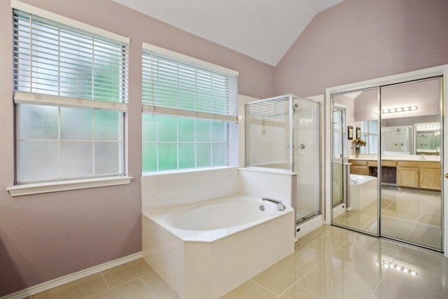 full bath featuring a garden tub, vanity, lofted ceiling, tile patterned floors, and a shower stall